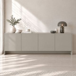 Film adhésif décoratif Cover Styl NE85 greige effet soie, finition Prestige, sur les façades d’un buffet dans un salon lumineux.